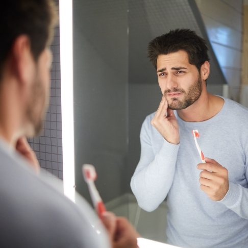 Man in pain before emergency dentistry
