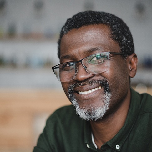 Close-up of senior man with glasses smiling