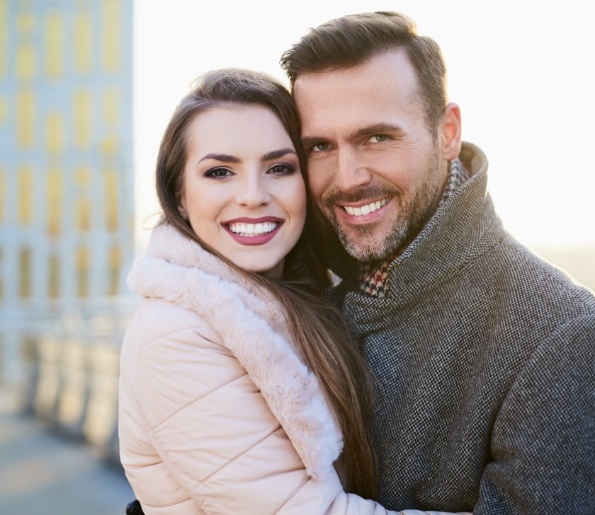 Man and woman with flawless smiles thanks to cosmetic dentistry