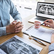 Dentistry team member explaining cost of cosmetic dentistry in Brookfield to dental patient