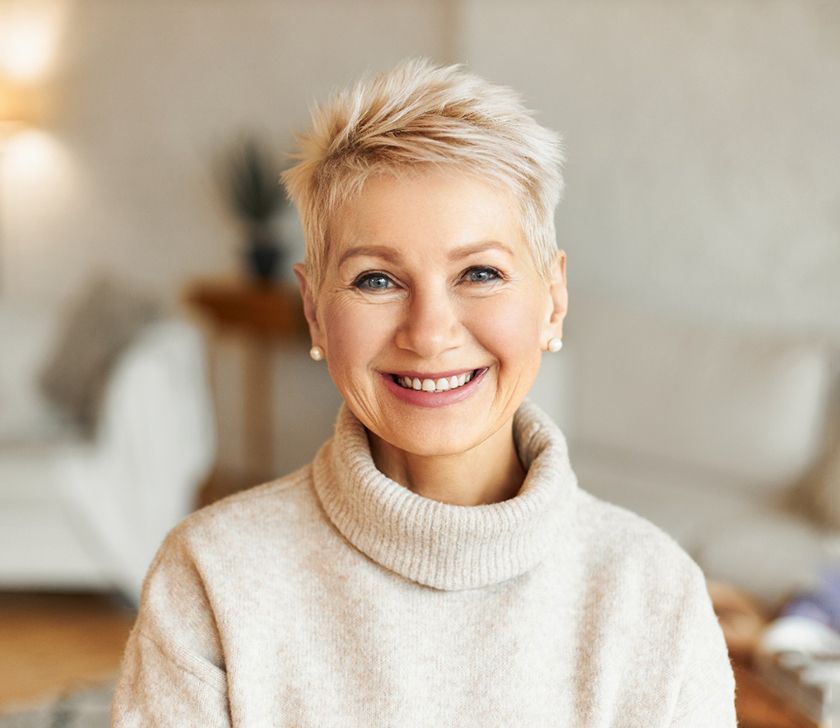 a woman smiling with her new dentures in Brookfield