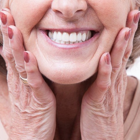 a woman smiling with brand-new dentures