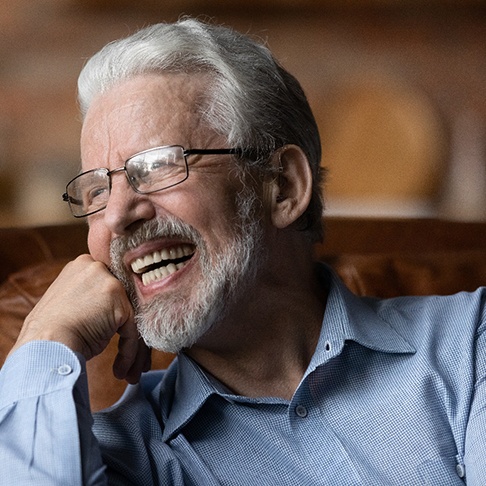 Man laughing on a couch
