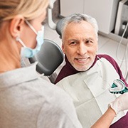 a patient smiling while undergoing the denture process