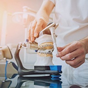 Dental lab technician operating articulator