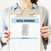 Holding a clipboard with a dental insurance form