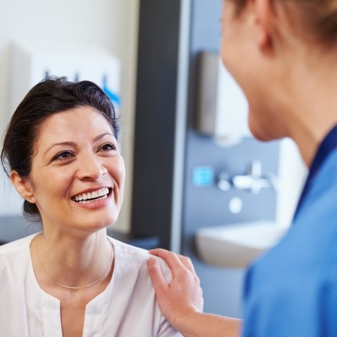 Dentist talking to dental patient after tooth extractions