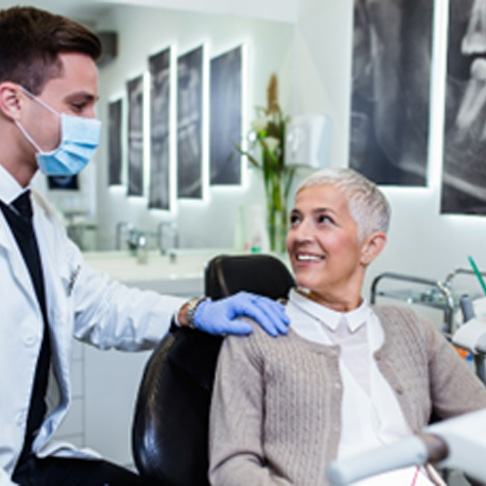 Mature patient smiling at dentist during routine checkup