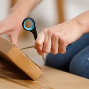 Patient using small scissors to open package