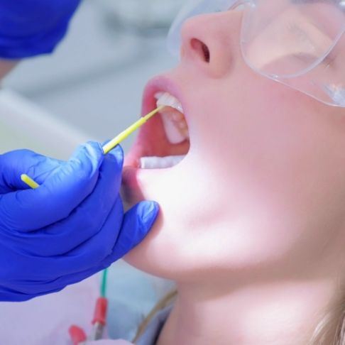 Dental patient receiving fluoride treatment