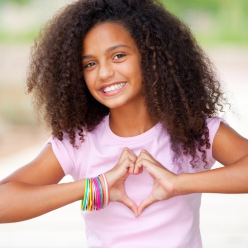 Child with healthy smile thanks to dental sealants