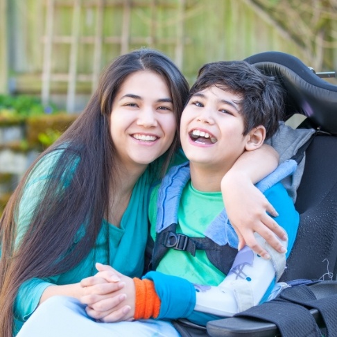 Two teens smiling after special needs dentistry visit