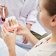 A dentist telling a patient about dental implants