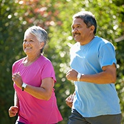 Couple smiling while jogging outside