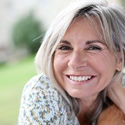 a patient smiling and showing off her dental implants in Brookfield