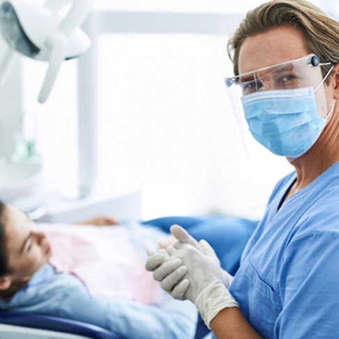 a dental professional explaining the implant denture procedure