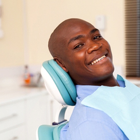 man smiling as a good candidate for implant dentures in Brookfield