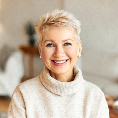 woman smiling and enjoying the benefits of implant dentures in Brookfield