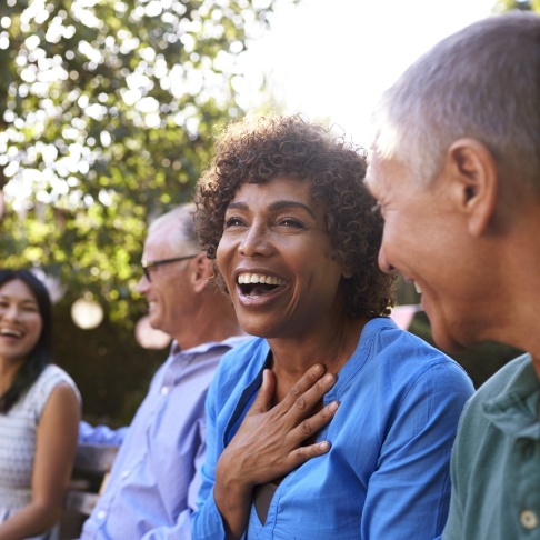 Woman laughing and enjoying the benefits of dental implants