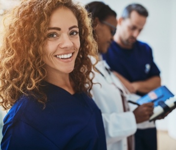 Three dental professionals working together