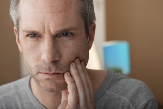 Man in pain before emergency dentistry