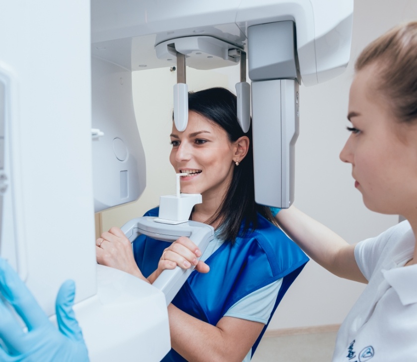 Woman receiving 3 D C T cone beam digital x-ray scanner