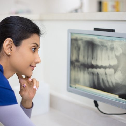 Dentist looking at digital x-rays