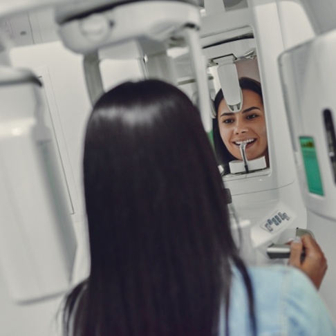 Woman receiving 3 D C T cone beam digital x-ray scans