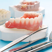 a complete denture set against a blue background