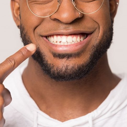 man pointing to his smile