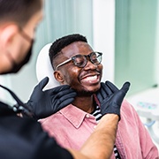 Man smiling at the denitst