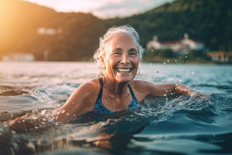 Woman smiles while swimming.